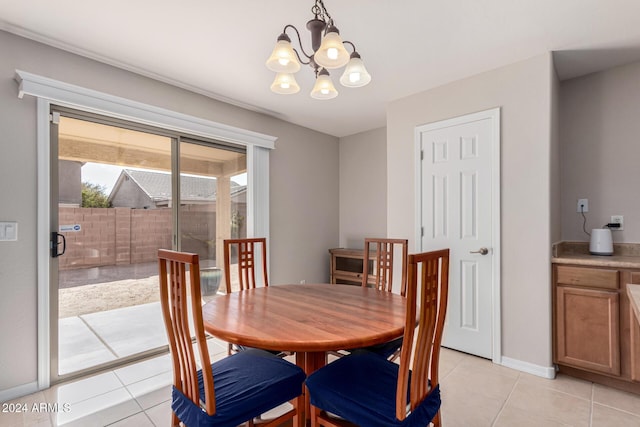 tiled dining room featuring a notable chandelier