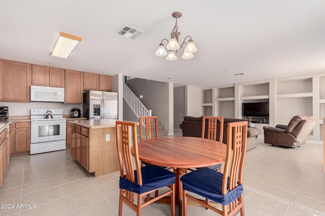 tiled dining area featuring a notable chandelier and built in features