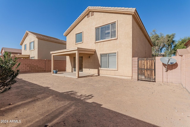 rear view of property featuring a patio