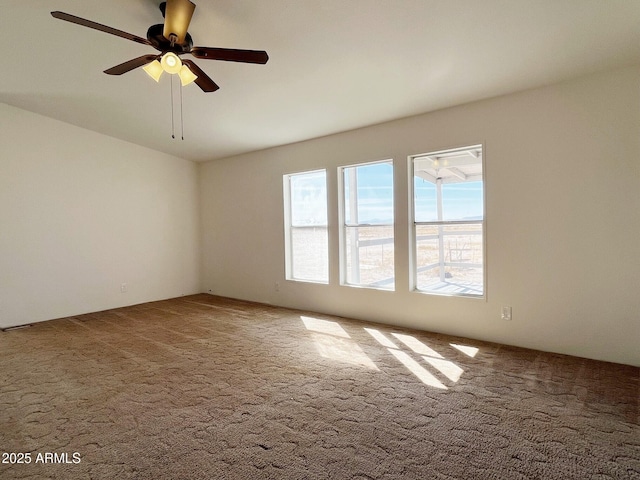 carpeted spare room with ceiling fan