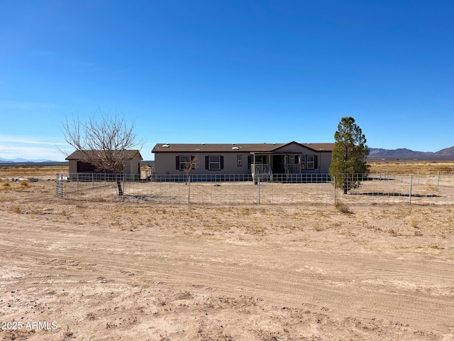 manufactured / mobile home with fence and a mountain view