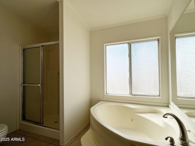 bathroom with crown molding, toilet, a shower stall, tile patterned flooring, and a whirlpool tub