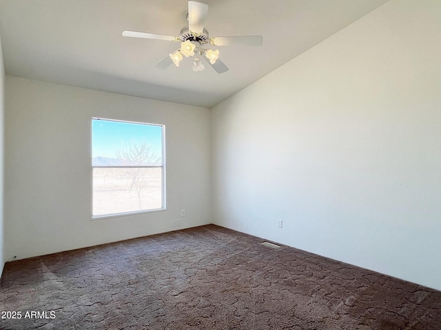 carpeted empty room featuring ceiling fan and lofted ceiling