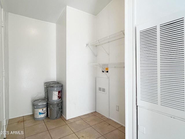 laundry room featuring hookup for a washing machine, laundry area, a heating unit, and light tile patterned floors