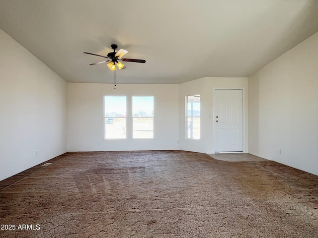 carpeted spare room featuring ceiling fan