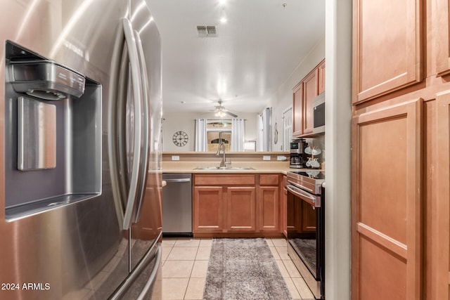 kitchen featuring ceiling fan, light tile patterned floors, sink, and appliances with stainless steel finishes