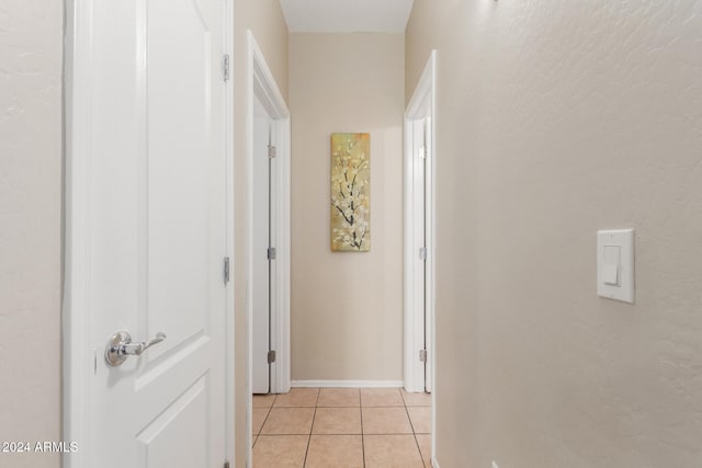 corridor with light tile patterned floors