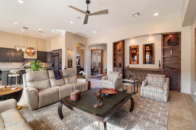 living room featuring ceiling fan and light tile patterned flooring