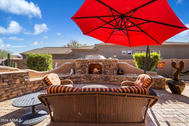 view of patio with an outdoor stone fireplace