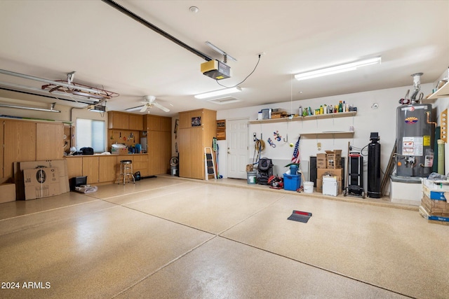 garage with a garage door opener, ceiling fan, and water heater