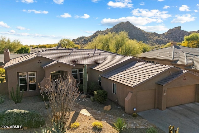 view of front facade featuring a mountain view and a garage