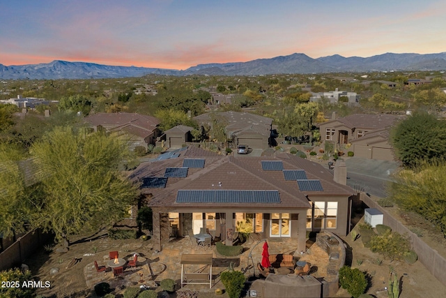 aerial view at dusk featuring a mountain view