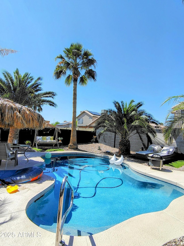 view of swimming pool featuring a fenced in pool and a patio