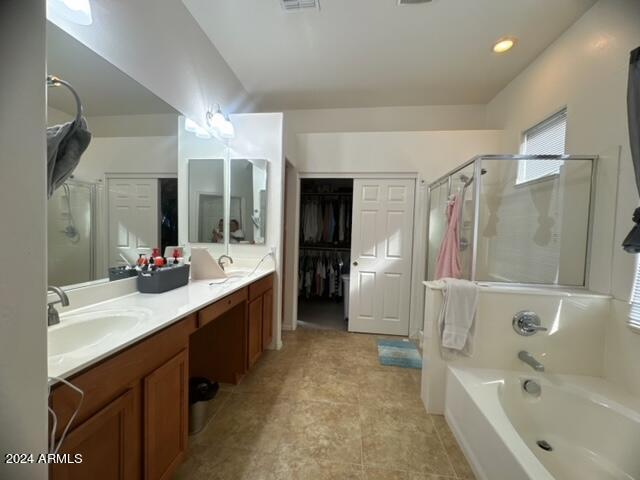 bathroom featuring vanity and separate shower and tub