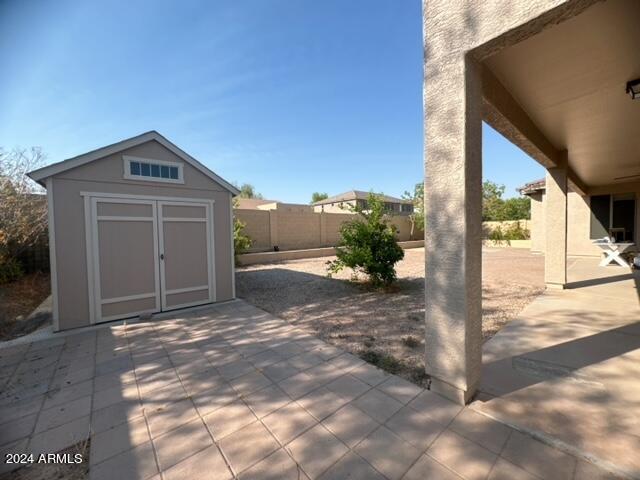 view of patio featuring a shed