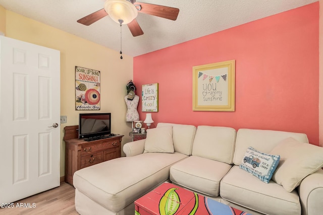 living room featuring a ceiling fan and light wood finished floors