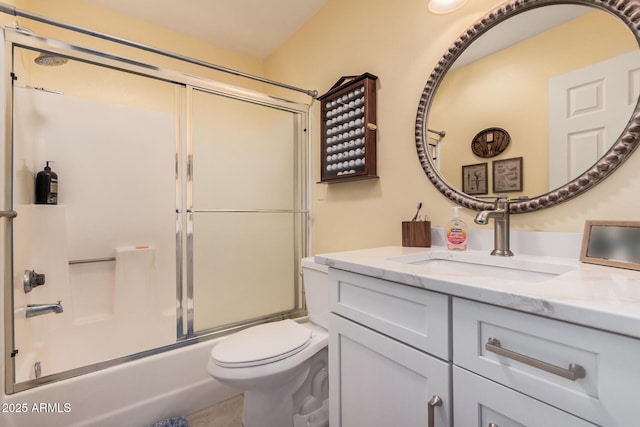 bathroom with combined bath / shower with glass door, vanity, and toilet