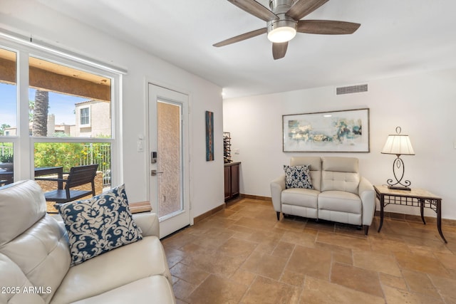 8787 E Mountain View Rd Unit 1100, Scottsdale, AZ 85258 - living room featuring stone tile floors, a ceiling fan, and baseboards