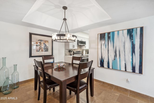 8787 E Mountain View Rd Unit 1100, Scottsdale, AZ 85258 - dining room with a tray ceiling, baseboards, and a chandelier