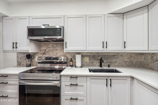 8787 E Mountain View Rd Unit 1100, Scottsdale, AZ 85258 - kitchen with appliances with stainless steel finishes, a sink, light countertops, and decorative backsplash
