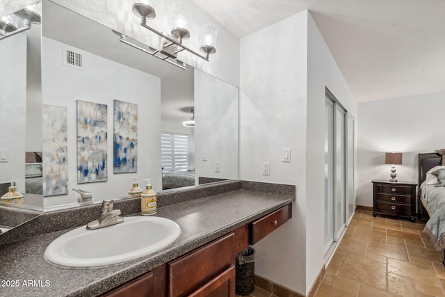 8787 E Mountain View Rd Unit 1100, Scottsdale, AZ 85258 - full bathroom with connected bathroom, baseboards, stone tile flooring, vanity, and a shower stall