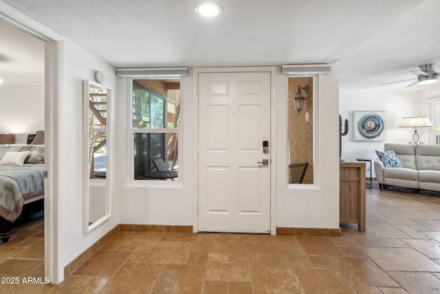 8787 E Mountain View Rd Unit 1100, Scottsdale, AZ 85258 - entrance foyer with stone tile flooring, baseboards, and a ceiling fan