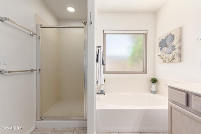 bathroom featuring a stall shower, a bath, vanity, tile patterned flooring, and recessed lighting