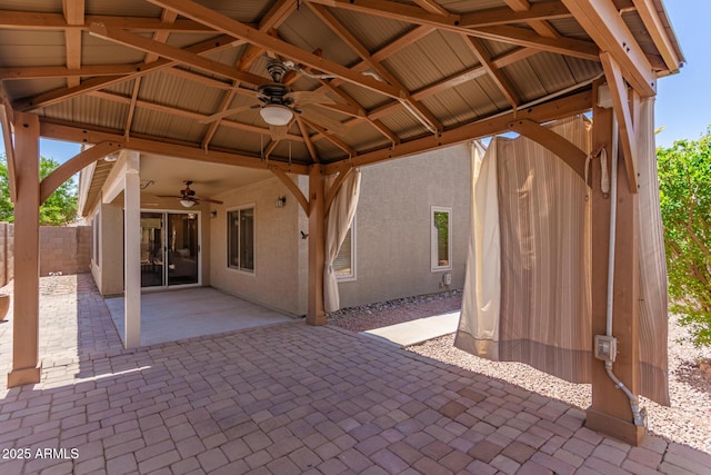 view of patio featuring a gazebo, a ceiling fan, and fence