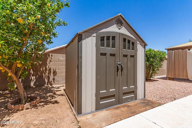 view of shed with fence