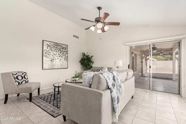 living room with a ceiling fan, light tile patterned floors, and vaulted ceiling