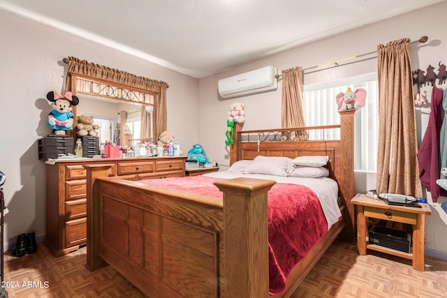 bedroom with a wall unit AC and parquet floors