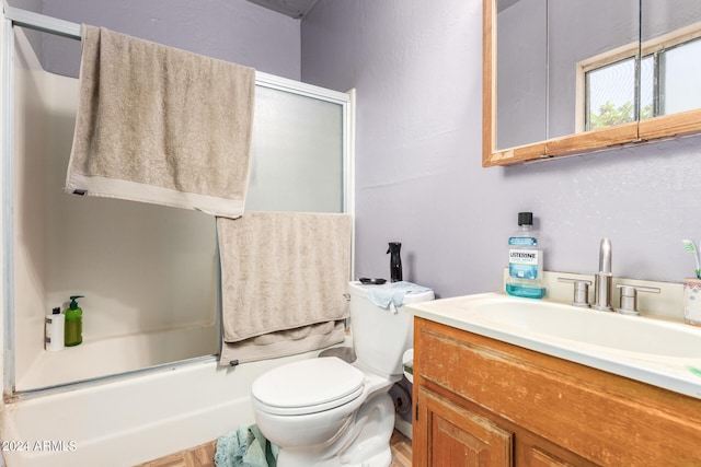 full bathroom featuring oversized vanity, toilet, and bath / shower combo with glass door