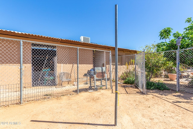 view of yard with central AC and an outdoor structure