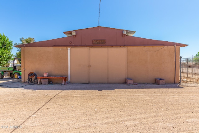 view of side of home featuring a shed