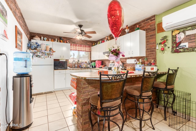 kitchen with a kitchen breakfast bar, white cabinets, a wall mounted air conditioner, white fridge, and ceiling fan