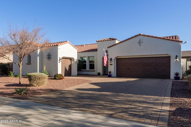 mediterranean / spanish home featuring a garage