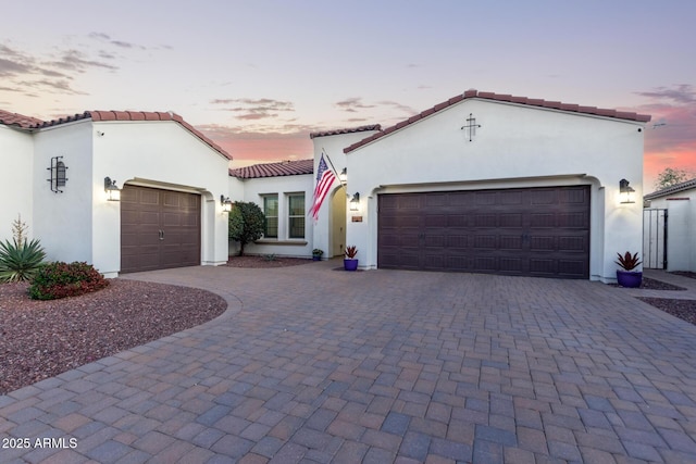 mediterranean / spanish-style house with a garage