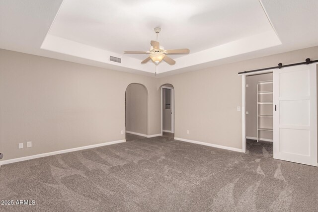 14602 N 63rd Pl, Scottsdale, AZ 85254 - unfurnished bedroom with a tray ceiling, carpet flooring, and arched walkways