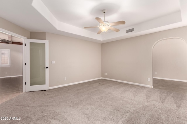 14602 N 63rd Pl, Scottsdale, AZ 85254 - unfurnished room with a raised ceiling, a ceiling fan, baseboards, and carpet floors