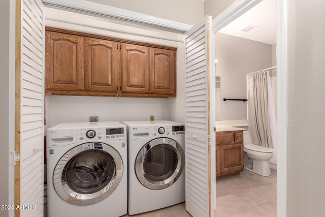 14602 N 63rd Pl, Scottsdale, AZ 85254 - laundry area with cabinet space, light tile patterned floors, and washing machine and dryer
