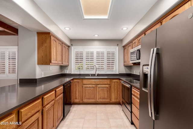 14602 N 63rd Pl, Scottsdale, AZ 85254 - kitchen with stainless steel appliances, a sink, dark countertops, light tile patterned floors, and recessed lighting