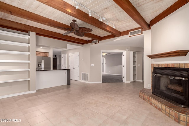 14602 N 63rd Pl, Scottsdale, AZ 85254 - unfurnished living room with a ceiling fan, beam ceiling, wood ceiling, a brick fireplace, and light tile patterned flooring