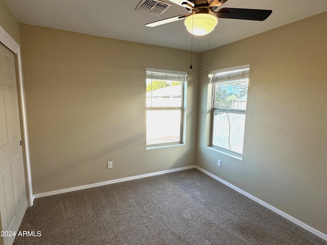 empty room featuring carpet and ceiling fan