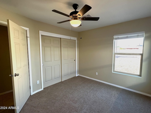 unfurnished bedroom with a closet, carpet flooring, and ceiling fan