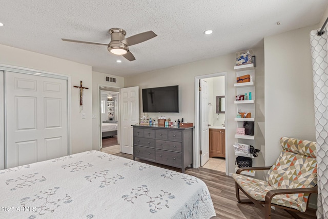 1235 E Dover St, Mesa, AZ 85203 - bedroom featuring recessed lighting, wood finished floors, a textured ceiling, a closet, and connected bathroom