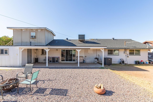 1235 E Dover St, Mesa, AZ 85203 - rear view of house with roof mounted solar panels, central air condition unit, a patio area, and roof with shingles