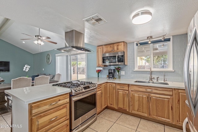 1235 E Dover St, Mesa, AZ 85203 - kitchen with appliances with stainless steel finishes, a sink, a peninsula, island range hood, and plenty of natural light