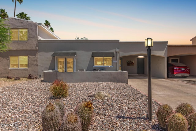 7736 E Rancho Vista Dr, Scottsdale, AZ 85251 - pueblo revival-style home with stucco siding and concrete driveway