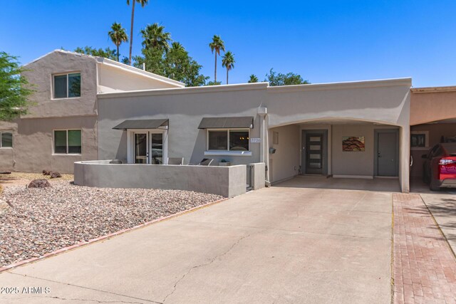 7736 E Rancho Vista Dr, Scottsdale, AZ 85251 - view of front of house with stucco siding, concrete driveway, and an attached carport