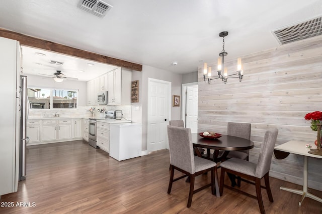 7736 E Rancho Vista Dr, Scottsdale, AZ 85251 - dining space featuring a chandelier, dark wood finished floors, and a ceiling fan